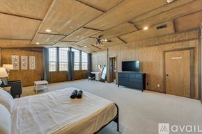 Celina house for rent - A bedroom with a large bed and a flat screen TV.