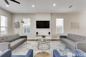 Dallas house for rent - A living room with a grey sofa, a coffee table, and a television.