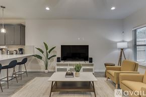 Dallas house for rent - A living room with a fireplace, chairs, and a coffee table.