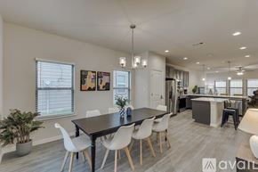 Dallas house for rent - A modern dining room with a black table and white chairs.