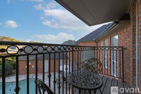 Mesquite house for rent - A balcony with a table and chairs overlooking a pool.