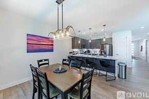 Lake Havasu City house for rent - A modern kitchen with a wooden dining table and chairs.