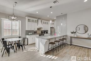 Rowlett house for rent - A modern kitchen with a dining table and chairs.