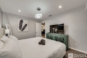 Arlington house for rent - A bedroom with two beds and a television in the corner.
