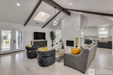 Dallas house for rent - A modern living room with a grey sofa and a black television.