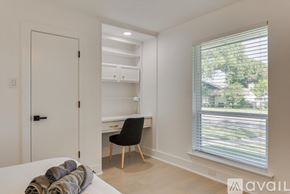 Dallas house for rent - A bedroom with a white bed and a black chair.