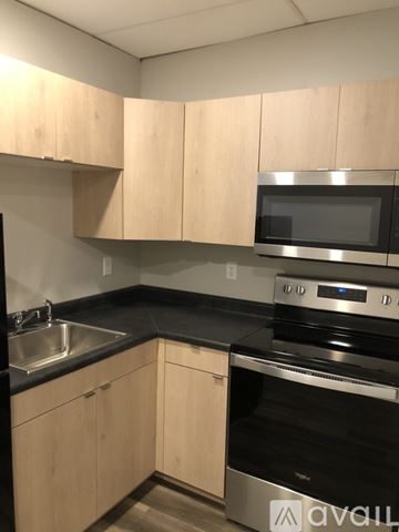 Willmar apartment for rent - A kitchen with wooden cabinets and stainless steel appliances.
