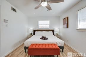 Dallas house for rent - A bedroom with a bed, a ceiling fan, and a window.
