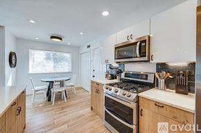Dallas house for rent - A kitchen with wooden cabinets and a stainless steel oven.