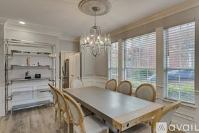 Rowlett house for rent - A dining room with a wooden table and chairs.