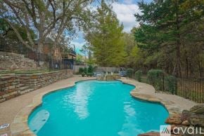 Rowlett house for rent - A small pool surrounded by a fence and trees.