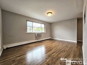 Chicago apartment for rent - A room with wooden flooring and a window.