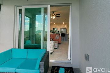 Punta Gorda condo for rent - A living room with a blue couch and a fan.