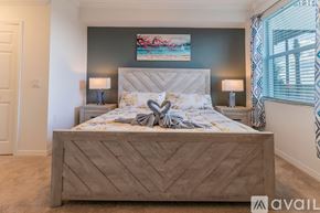 Punta Gorda condo for rent - A bedroom with a large bed and a painting on the wall.