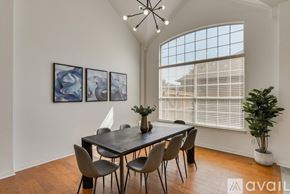 Rowlett house for rent - A dining room with a table set for four and a chandelier.