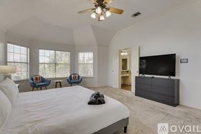 Plano house for rent - A bedroom with a large bed and a flat screen TV.