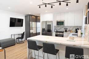 Los Angeles apartment for rent - A modern kitchen with a bar area and a television.