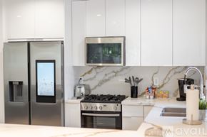 Los Angeles apartment for rent - A modern kitchen with a stainless steel refrigerator and a marble backsplash.