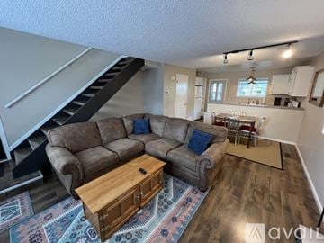 Cheyenne house for rent - A living room with a brown couch and a wooden coffee table.