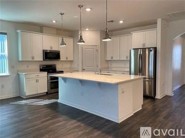 Oakland house for rent - A kitchen with white cabinets and a large island.