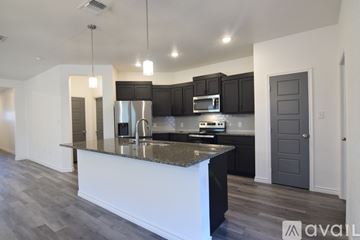 Temple house for rent - A kitchen with a white island and dark wood cabinets.