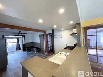 Bremerton house for rent - A kitchen with a sink and a refrigerator.