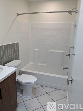 Eureka house for rent - A white toilet sits next to a white bathtub in a bathroom.