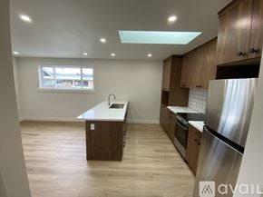 Eureka house for rent - A kitchen with wooden cabinets and a stainless steel refrigerator.