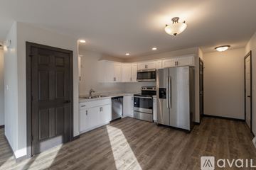 Plover house for rent - A modern kitchen with stainless steel appliances and wooden flooring.