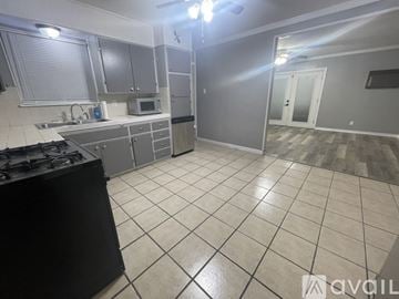 Killeen house for rent - A kitchen with a black stove top oven and a tiled floor.