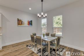 Dallas house for rent - A dining room with a wooden table and chairs.