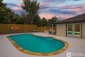 Garland house for rent - A pool surrounded by a wooden fence with a lifebuoy hanging on it.