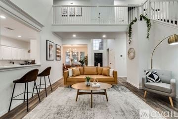 Haltom City house for rent - A living room with a brown sofa and a grey armchair.