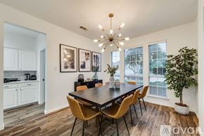Haltom City house for rent - A dining room with a wooden table and chairs.