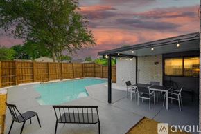 Dallas house for rent - A backyard with a pool, patio furniture, and a house.