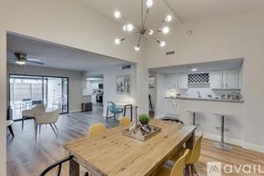 Dallas house for rent - A modern dining room with a wooden table and chairs.