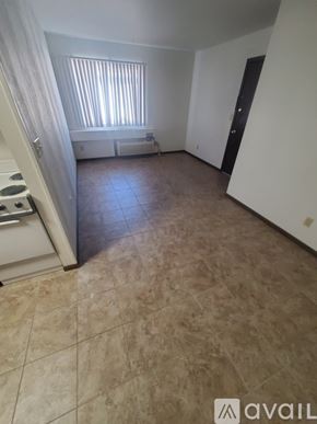 La Crosse apartment for rent - A room with tiled flooring and a window with blinds.