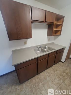La Crosse apartment for rent - A kitchen with brown cabinets and a marble countertop.