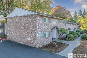 Portland apartment for rent - A brick house with a sign that says "Open" on it.