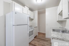 Portland apartment for rent - A kitchen with a white refrigerator, stove, and sink.