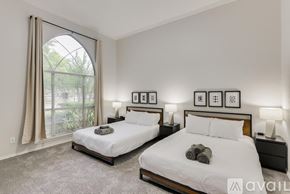 Mesquite house for rent - Two twin beds in a bedroom with a window and a carpet.