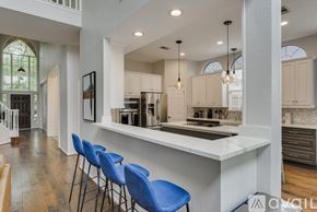 Mesquite house for rent - A kitchen with a white counter and blue chairs.