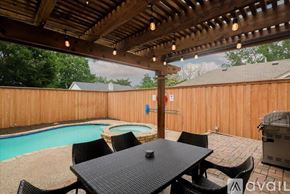 Plano house for rent - A patio with a table and chairs and a pool.