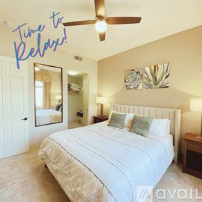La Quinta condo for rent - A bedroom with a large bed and a ceiling fan.