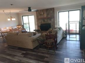 Dillard house for rent - A living room with a couch, chairs, and a television.