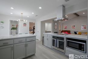 Richardson house for rent - A modern kitchen with grey cabinets and stainless steel appliances.