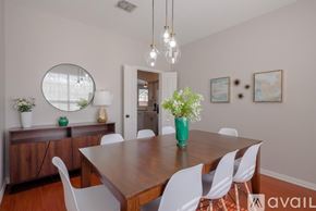 Grand Prairie house for rent - A dining room with a wooden table and white chairs.