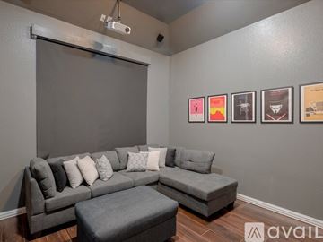 Mckinney house for rent - A living room with a grey couch and a grey ottoman.