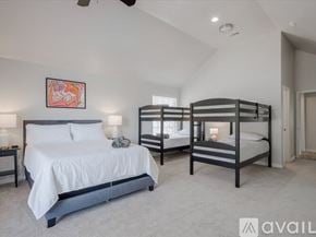 Mckinney house for rent - A bedroom with a large bed and a bunk bed.