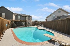 Mckinney house for rent - A small residential pool with a concrete border and a wooden deck.